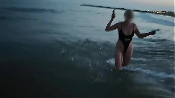 Blonde shows tits and sucks cock on a public beach
